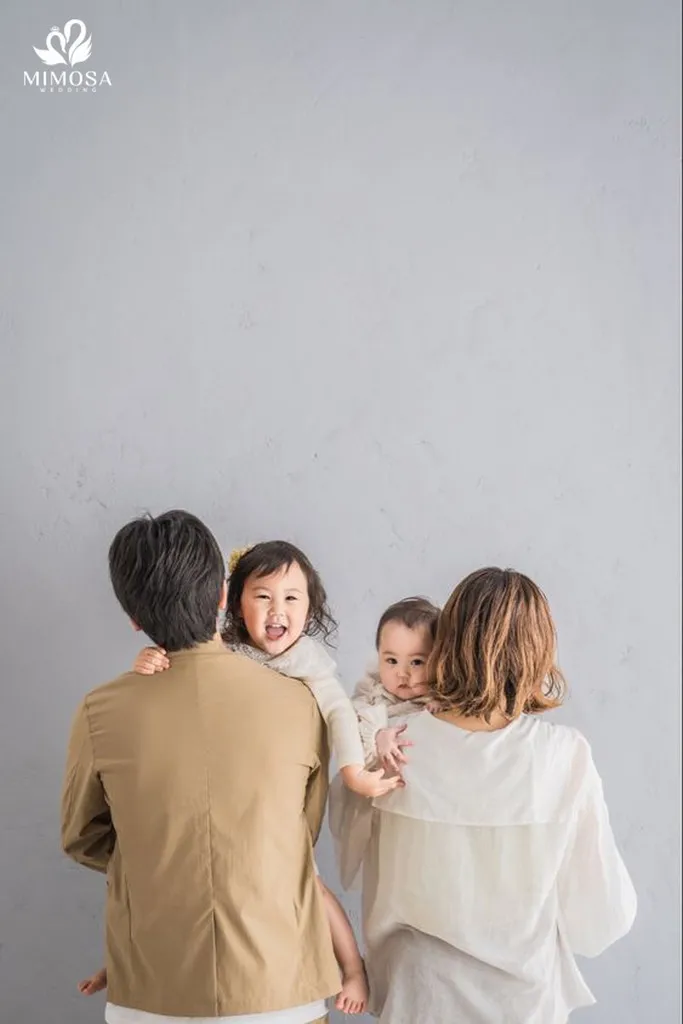 Tư thế bố mẹ đứng giữa, hai con đứng hai bên khi chụp ảnh gia đình 4 người trong studio